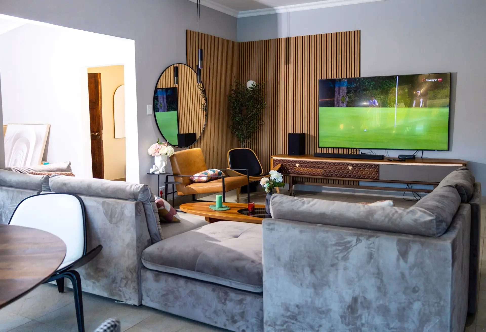 Lounge with slatted timber feature wall and large screen