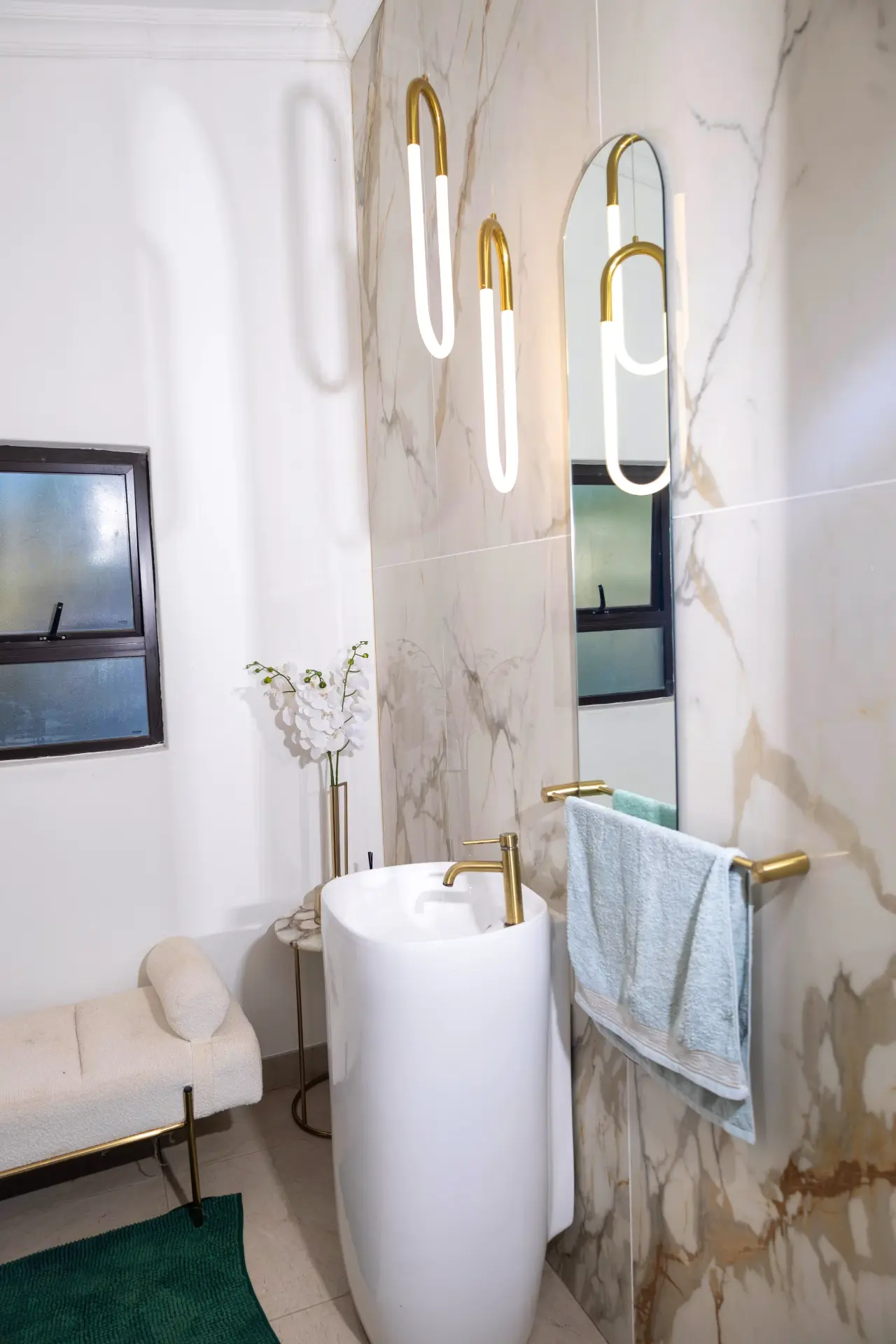 Marble en-suite bathroom with brass fittings